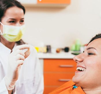 Dentist holding patient’s extracted tooth