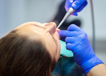 Person receiving dental care while under oral sedation