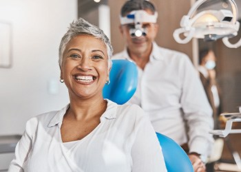 Woman smiling while sitting in treatment chair