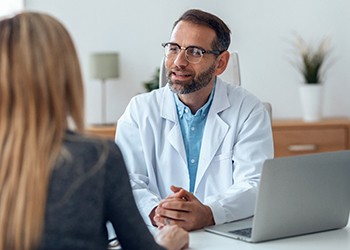 dentist speaking to patient for implant consultation