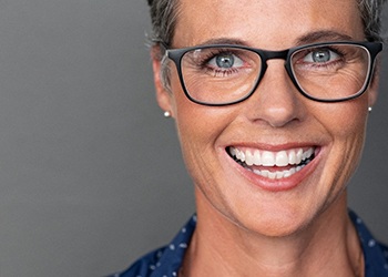 patient smiling after getting dental implants