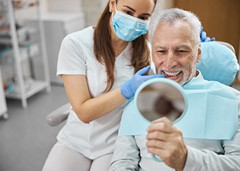 patient smiling after getting dental implants