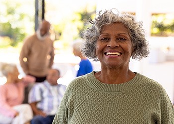 Closeup of woman in green sweater smiling