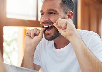 Day to day benefits of dental implants include the ability to brush and floss your teeth with ease