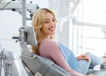 Patient smiling while sitting in treatment chair
