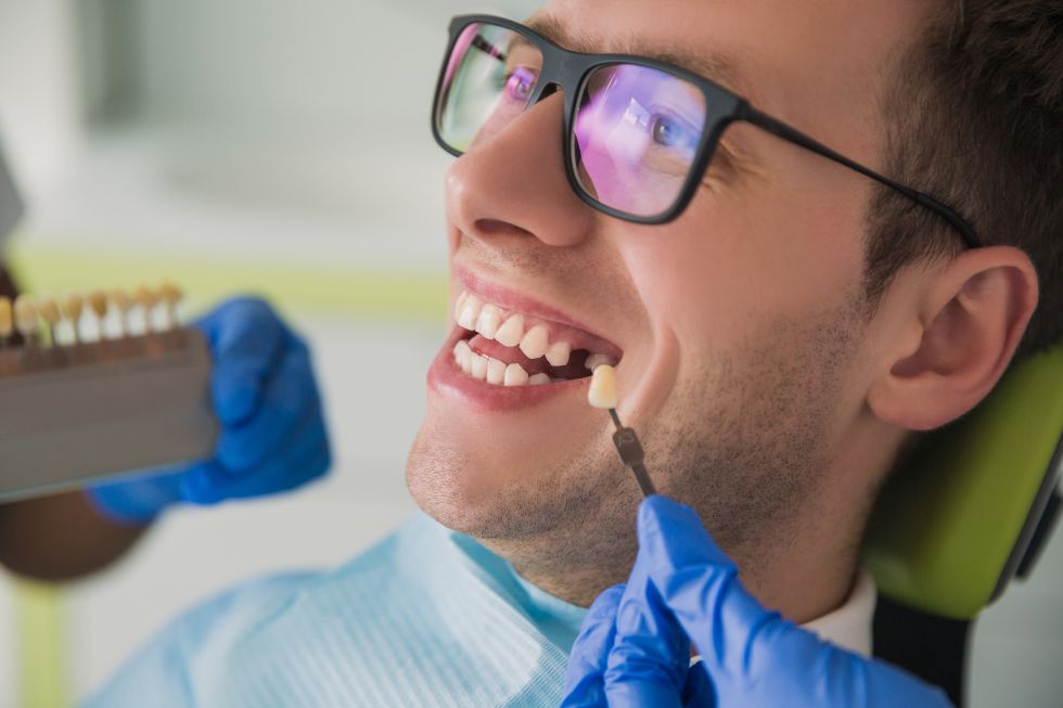 A man replacing a lost tooth with a dental implant