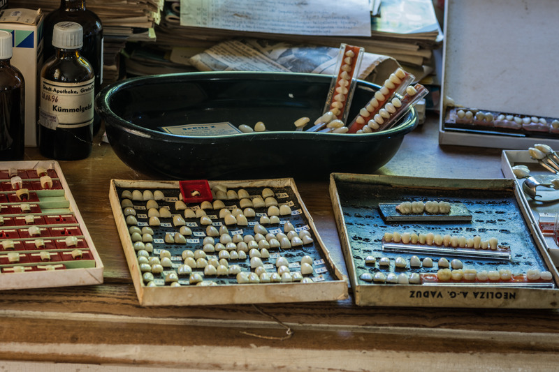 Desk covered in old dentures and teeth from history