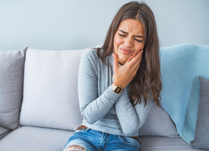 Woman holding jaw in pain